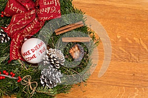 Christmas decoration on wooden background with message: Make Dreams Come True.