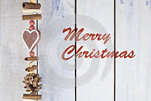 Christmas decoration on a wooden background with text in English `Merry Christmas`