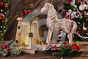 Christmas decoration with wooden horse and retro candle lantern