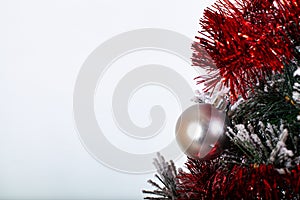 Christmas decorationred silver ball in a snowed tree with tinsel