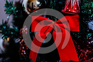 Christmas decorations against blurred background. Red Christamas ribbon