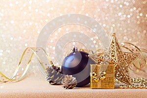 Christmas decorations in black and gold over glitter background