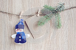 Christmas decorations with a blank card hanging over wooden back