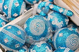 Christmas decorations in boxes. Balls for the Christmas tree of blue light. Christmas preparation concept. Christmas background