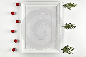 Christmas decorations in bright white colors with picture frame with white wall background.