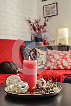 Christmas decorations with candle on coffee table in living room