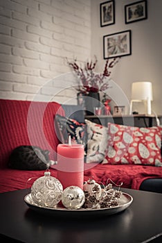 Christmas decorations with candle on coffee table in living room