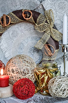 Christmas decorations with candle, ribbons and balls