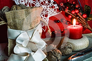 Christmas decorations with candle, ribbons and walnuts