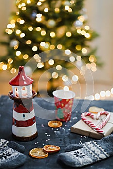 Christmas decorations, candles, candy cane, orange slices and Christmas tree with bokeh lights. Christmas, New Year 2021 concept