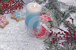 Christmas decorations for Christmas, wreaths and a candle and homemade gingerbread on a light background. The atmosphere of the ho