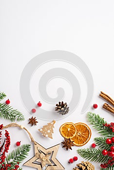 Christmas decorations concept. Top view vertical photo of wooden star ornament dried orange slices cinnamon sticks mistletoe