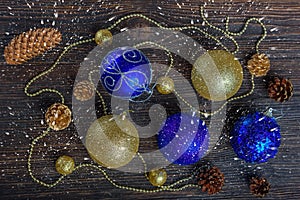 Christmas decorations, cones on a dark wooden background. New year`s card, top view