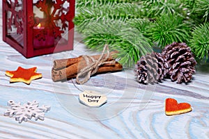 Christmas Decorations with cup of hot cocoa, lamp with candle, cinnamon sticks, pine, fir branch on wooden light blue table