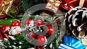 Christmas decorations - decorative spruce branches with berries and cones, candies, gifts, snowflakes rotate in circle.