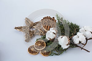 Christmas decorations eco cotton flowers, cinnamon,stars, spruce branches and jute rope hank over white background,holiday,xmas,ch