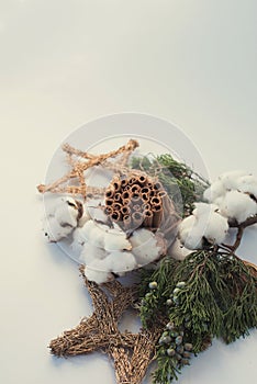 Christmas decorations eco cotton flowers, cinnamon,stars, spruce branches and jute rope hank over white background,holiday,xmas,ch