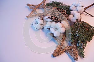 Christmas decorations eco cotton flowers, cinnamon,stars, spruce branches and jute rope hank over white background,holiday,xmas,ch