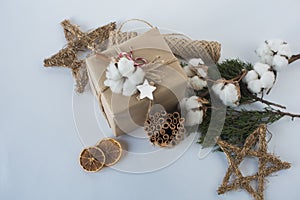 Christmas decorations eco cotton flowers, cinnamon,stars, spruce branches and jute rope hank over white background,holiday,xmas,ch