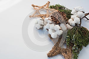 Christmas decorations eco cotton flowers, cinnamon,stars, spruce branches and jute rope hank over white background,holiday,xmas,ch