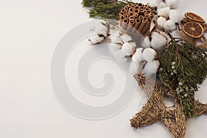 Christmas decorations eco cotton flowers, cinnamon,stars, spruce branches and jute rope hank over white background,holiday,xmas,ch