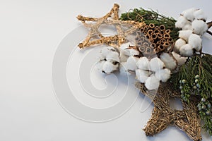 Christmas decorations eco cotton flowers, cinnamon,stars, spruce branches and jute rope hank over white background,holiday,xmas,ch