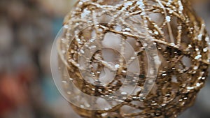 Christmas decorations. festive accessories. close-up. Christmas tree toy in the form of a ball made of gold threads and