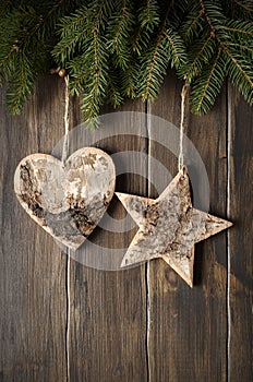 Christmas decorations. Fir branches and shape of  heart, star on a wooden background with copy space. Top view