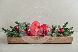 Christmas decorations from fir tree branches and red christmas balls