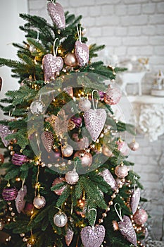 Christmas decorations on a fir tree close-up. Toys, cones, garlands with lights, balls, beads. New year,