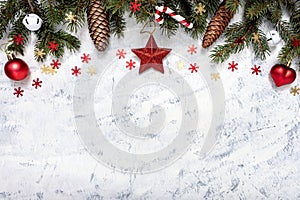Christmas decorations and fir tree on white-grey background