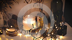 Christmas decorations, flashing lights, New Year 2022, 4k background. Xmas candle, fir cones, bottles