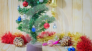 Christmas decorations focusing on red ball on pine tree