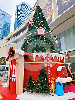 Christmas decorations in front of a large shopping mall with skyscrapers in the background in Shenzhen.