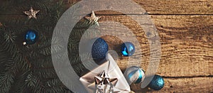 Christmas decorations and gift boxes over wooden board