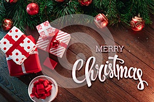 Christmas decorations and gifts, pine branches, the inscription of a marry christmas, on a wooden table. Merry Christmas and happy