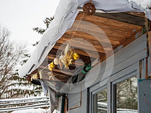 Christmas decorations glass globes on the chalet covered with snow early in