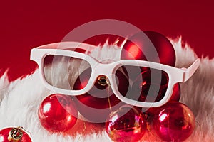 Christmas decorations, glasses on a red background. New Year movies