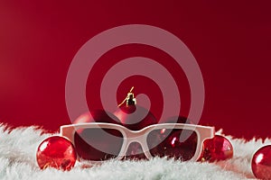 Christmas decorations, glasses on a red background. New Year ophthalmic