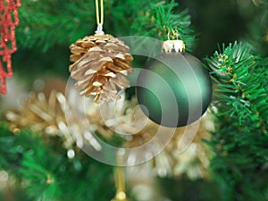 Christmas decorations green tree hanging, green ball, gold Pine cones, wrapped around it with a gold ribbon on white background