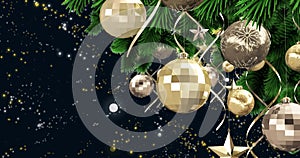 Christmas decorations hanging on christmas tree against yellow spots of light on black background