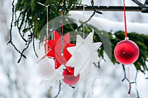Christmas decorations hanging from a tree in a street food market, Christmas baubles and stars
