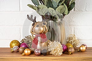 Christmas decorations indoor - Shelf with candles, eucalyptus branches and golden decor.