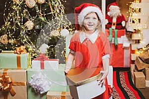 Christmas decorations. Kids enjoy the holiday. Christmas child holding a red gift box. Happy little girl child with