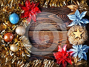 Christmas decorations. Mock up vintage New Year decorations on dark wooden background with copy space. Frame with garlands, balls