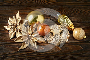 Christmas decorations. New Year`s decorations on a dark wooden background. Garlands, balls, stars and toys for Christmas decor.