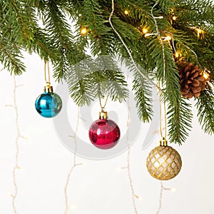Christmas decorations on pine branches isolated on white background