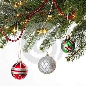 Christmas decorations on pine branches isolated on white background