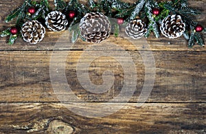 Christmas decorations with pine cones, fir tree branches and red balls