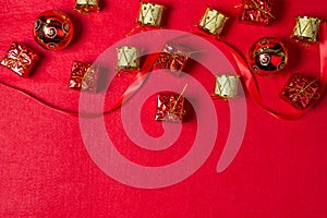 Christmas decorations on a red background. Holiday decorations. Red gift boxes. golden toy drums. Christmas concept.